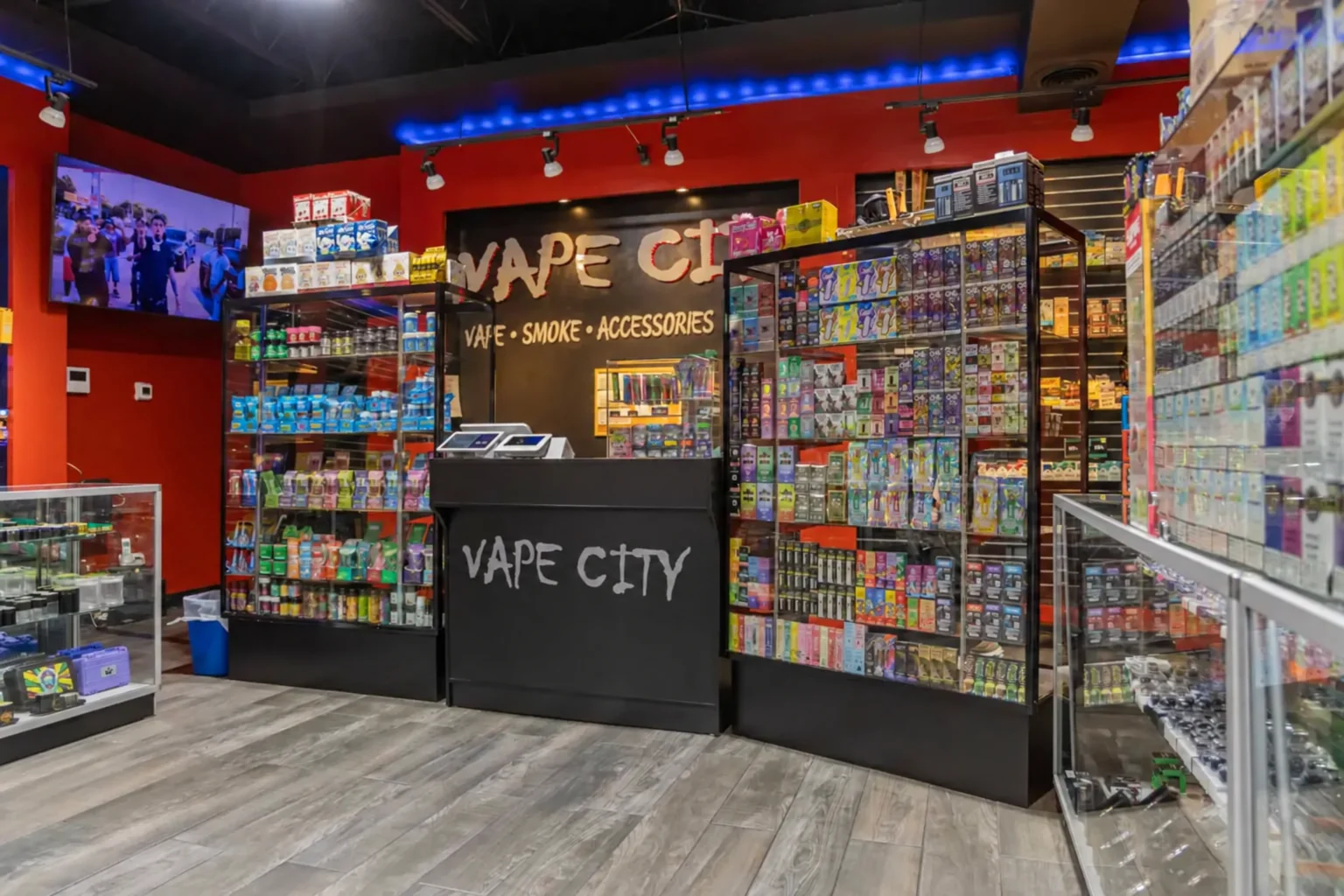 Inside a Vape City store with shelves of vapes and accessories